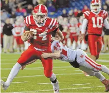  ?? STAFF PHOTO BY STUART CAHILL ?? TOUGH TO STOP: Peter Oliver (24) drags North Attleboro’s Adam Eberle while helping St. John’s (Shrewsbury) to a Division 3 Super Bowl victory last night.