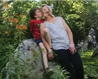  ?? COLE BURSTON FOR THE TORONTO STAR ?? Eric Polo, 9, with his mother, Daphne, at Spiral Garden. The program offers offers kids receiving treatment or who have disabiliti­es a chance to enjoy a summer camp experience without travelling far from Toronto.