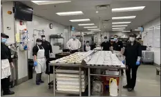  ?? SUBMITTED PHOTO ?? Springfiel­d Country Clufi stafi including Steven Balmer, efiecutive chef, third from lefi, Pat Burns, president and CEO, fourth from lefi, and Nancy Steinmetfi, efiecutive vice president, far right, prepare meals for the hungry.fi