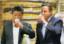  ?? Photo / AP ?? Britain's then Prime Minister David Cameron, right, drinks beer with Chinese President Xi Jinping.