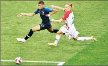  ?? (AFP/AP) ?? Left: France forward Kylian Mbappe (left), vies for the ball with Croatia defender Domagoj Vida (right), during the Russia 2018 World Cup final football match between France and Croatia at the Luzhniki Stadium in Moscow onJuly 15. (Right): Mbappe holds the award for best young player at the end of the final match.