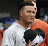  ?? GAIL BURTON — THE ASSOCIATED PRESS ?? Baltimore Orioles’ Manny Machado pauses for the singing of God Bless America in the seventh inning of a baseball game against the Texas Rangers, Sunday in Baltimore.