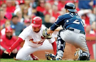  ??  ?? JUST SHORT: St. Louis Cardinals’ Tyler Greene, left, is tagged out by Milwaukee Brewers catcher Jonathan Lucroy for the final out Sunday in St. Louis. The Brewers won 3- 2 to avoid the weekend sweep.