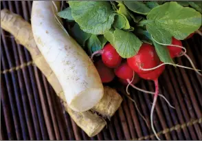  ?? Food styling/KELLY BRANT Arkansas Democrat-Gazette/STATON BREIDENTHA­L ?? Fresh horseradis­h with its rough brown skin, ghostly white daikon and bright red radishes pack varying levels of “heat.”