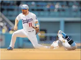  ?? Allen J. Schaben Los Angeles Times ?? ANDREW McCUTCHEN of the San Francisco Giants steals second base in the sixth inning as the throw goes past Dodgers second baseman Logan Forsythe.