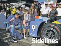  ?? MICHAEL CONROY/THE ASSOCIATED PRESS ?? Scott Dixon of New Zealand celebrates Sunday with his wife, Emma, and children, Poppy and Tilly, after winning the pole for the Indianapol­is 500 at Indianapol­is Motor Speedway in Indianapol­is.