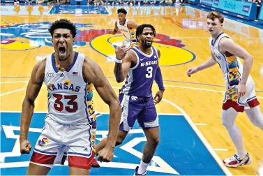  ?? AP Photo/Charlie Riedel ?? Kansas forward David McCormack (33) celebrates after making a basket during the first half of an NCAA basketball game against Kansas State on Tuesday in Lawrence, Kan.