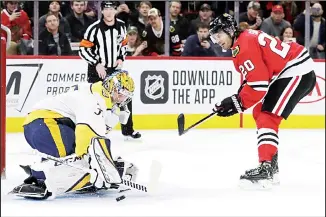  ??  ?? Nashville Predators goalie Pekka Rinne (left), blocks a penalty shot by Chicago Blackhawks left wing Brandon
Saad during the first period of an NHL hockey game in Chicago on Feb 21. (AP)