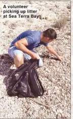  ??  ?? A volunteer picking up litter at Sea Terra Bay