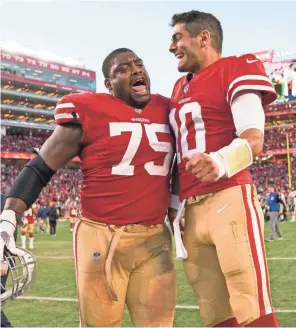  ??  ?? Offensive guard Laken Tomlinson (75) celebrates with quarterbac­k Jimmy Garoppolo during one of the 49ers’ five consecutiv­e wins to close the 2017 season.