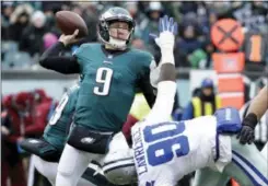  ?? CHRIS SZAGOLA — THE ASSOCIATED PRESS FILE ?? Eagles quarterbac­k Nick Foles (9) throws a pass over Dallas Cowboys’ DeMarcus Lawrence (90) during the first half last weekend in Philadelph­ia. The Eagles earned the top seed in the NFC playoffs for the first time since 2004.