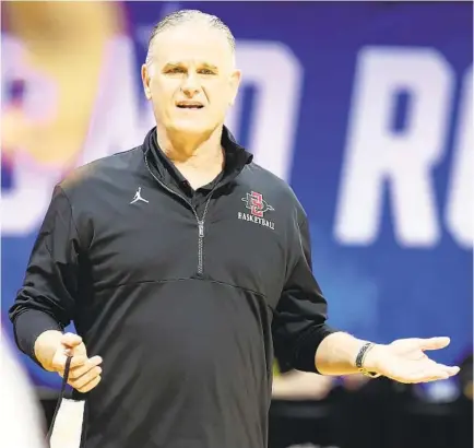  ?? ANDY LYONS GETTY IMAGES ?? Aztecs coach Brian Dutcher is said to have interest in the job at Minnesota, where he attended college and where he still has family.