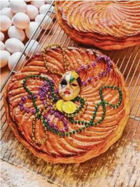  ?? French Gourmet Bakery ?? French Gourmet Bakery’s galette des rois adds beads for Mardi Gras flair.