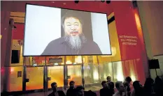  ?? ROBERT VOS/GETTY IMAGES ?? Chinese dissident artist Ai Weiwei, announces on a screen the winners of the 18th edition of the Hivos Tiger Awards in Rotterdam, in the Netherland­s, in February, 2013.
