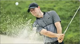  ?? Andrew Redington Getty Images ?? RORY McILROY plays a shot from a bunker during a practice round ahead of the 2016 PGA Championsh­ip at Baltusrol Golf Club.