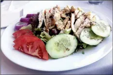  ?? Arkansas Democrat-Gazette/PHILIP MARTIN ?? The Athenian salad, served here with grilled chicken, contains Romaine, tomato, cucumber, red onion, kalamata olives, boiled eggs, feta and anchovies at The Terrace Mediterran­ean Kitchen in Little Rock.