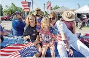  ??  ?? Members of the Edmond Daughters of the American Revolution sit together on the annual LibertyFes­t parade on Wednesday.