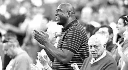  ?? EZRA SHAW/GETTY ?? Co-owner Magic Johnson and ex-manager Tommy Lasorda cheer on the Dodgers in 2017.