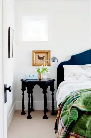  ??  ?? RIGHT In the master bedroom, the side table lends an exotic Moorish look while the avian-motif bedding offers a hit of whimsy. White Wisp OC-54 WALL PAINT, Benjamin Moore; custom BED FRAME, Van Gogh Designs; BED FRAME FABRIC, Pace Fabrics; SIDE TABLE,...