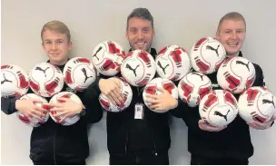  ??  ?? Soccersixe­s staff with the Puma balls – pictured (from left) are Corey Cousins, Kieron Mulholland and Connor Lawson.