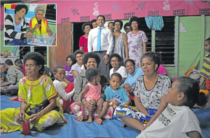  ?? Photo: Wati Talebula. ?? Supervisor of Elections Mohammed Saneem with women and children of Dogoru Village on March 14, 2018. INSET: Melanaia Diqiso (left) and Kinisimere Watisici looks at the set up of how the election day will be during election day at Dogoru Village.