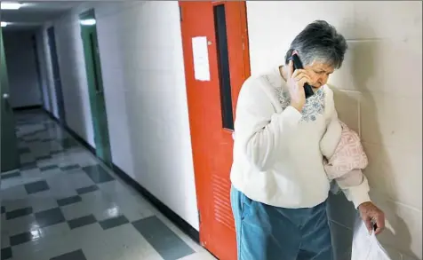  ?? Nate Guidry/Post-Gazette photos ?? Sister Janice Vanderneck speaks with a client on the phone at Casa San Jose in Brookline.