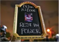  ?? CHRISTIAN MONTERROSA/ASSOCIATED PRESS ?? A protester holds a sign with a picture of Dijon Kizzee, who died after being shot by deputies of the Los Angeles County Sheriff’s Department on Monday.