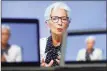  ?? Bloomberg ?? Christine Lagarde, president of the European Central Bank, is seen on a TV screen speaking during a live stream video of the central bank’s virtual rate decision news conference in Frankfurt, Germany, on Oct. 29.