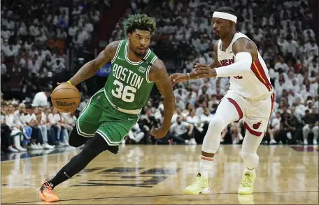  ?? AP ?? HEALTHY RETURN: Celtics guard Marcus Smart dribbles around Miami Heat forward Jimmy Butler during the first half of Game 2 of the Eastern Conference Finals on Thursday night in Miami.