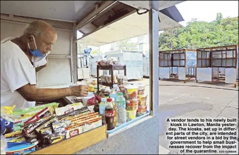  ?? EDD GUMBAN ?? A vendor tends to his newly built kiosk in Lawton, Manila yesterday. The kiosks, set up in different parts of the city, are intended for street vendors in a bid by the government to help small businesses recover from the impact of the quarantine.