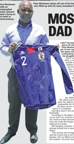  ??  ?? Pitso Mosimane holds an autographe­d Japan national team's jersey at his home in Johannesbu­rg.