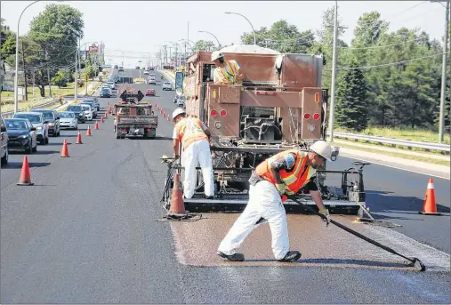  ?? JIM DAY/THE GUARDIAN ?? City of Charlottet­own road crews work on resurfacin­g a portion of University Avenue. The city has a resurfacin­g rating system to determine what level of repair work is needed for each city street each year.