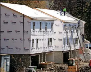 ?? AP/ GENE PUSKAR ?? Constructi­on continues on new houses in Canonsburg, Pa., as housing starts rose 11.3 percent in December, the Commerce Department said Thursday.
