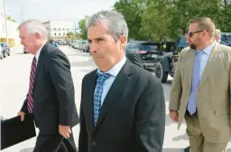  ?? REBECCA BLACKWELL/AP ?? Carlos De Oliveira, center, property manager at Mar-a-Lago, leaves the federal courthouse Tuesday in Fort Pierce, Florida, following his arraignmen­t hearing.