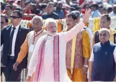  ??  ?? Prime Minister Narendra Modi waves as he attends the stone laying ceremony at Vishva Umiya Foundation in Gyaspur village, on the outskirts of Ahmedabad, on Monday. — AFP