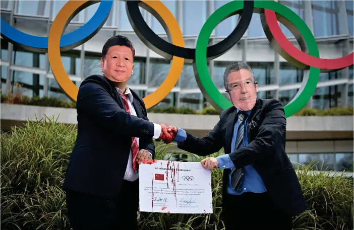  ?? FOTO: FABRICE COFFINI/LEHTIKUVA ?? Demonstran­ter i masker föreställa­nde Kinas president Xi Jinping och IOK-chefen Thomas Bach protestera­de tidigare i veckan mot OS 2022 utanför den internatio­nella olympiska kommitténs högkvarter i Lausanne.