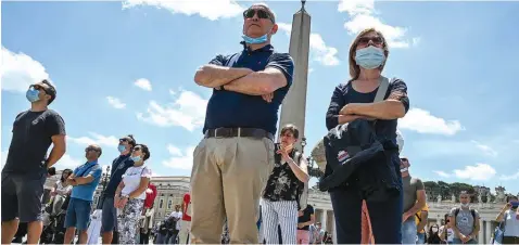  ??  ?? People watching as Pope Francis salutes from the window of the Apostolic Palace overlookin­g Saint Peter’ Square after his live streamed Angelus prayer in Vatican… yesterday. PHOTO: AFP