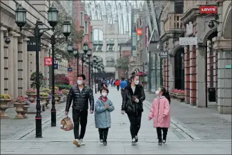  ?? WANG JING / CHINA DAILY ?? Residents stroll (top) along Hanjie Street, a pedestrian-only commercial area, in Wuhan, Hubei province, on March 30 last year, shortly after the area resumed operations. Wuhan lifted a 76-day lockdown on April 8 that year after COVID-19 was brought under control in the city.