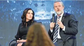  ?? STEVE HELBER/AP ?? Jerry Falwell Jr., accompanie­d by his wife, Becki, speaks at a 2018 town hall at Liberty University. Falwell has resigned as head of the school.