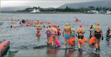 ??  ?? The large field of swimmers took to the water at Corran narrows on Saturday morning.