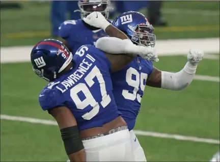  ?? COREY SIPKIN — THE ASSOCIATED PRESS ?? New York Giants’ Leonard Williams, right, celebrates a sack with Dexter Lawrence during the second half of Sunday’s game.