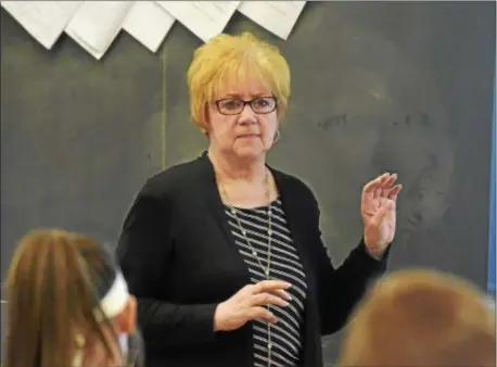  ?? PETE BANNAN – DIGITAL FIRST MEDIA ?? St. James Regional Catholic School teacher Cheryl Scartozzi discusses Agatha Christie with her eighth-grade class. Scartozzi is one of 19 county educators honored with the Excellence in Teaching Awards.