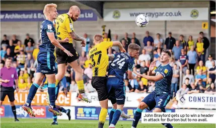  ?? ?? John Brayford gets up to win a header in attack for Burton but to no avail.