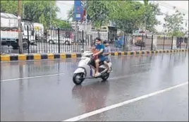  ?? MANOJ DHAKA/HT ?? Boys enjoying a scooter ride in Rohtak during rain on Monday. Rain also lashed other districts of Haryana, including Jind, Bhiwani, Hisar, Karnal, Panipat, Sonepat and Fatehabad.