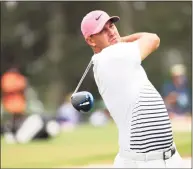  ?? Mike Ehrmann / Getty Images ?? Brooks Koepka plays his shot from the third tee during the second round of the Masters at Augusta National Golf Club on Friday.