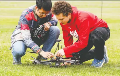  ?? PHOTOS: JOHN MAHONEY ?? The national championsh­ips are “freakin’ hard,” says McGill student Alex Gouyet, right, inspecting a drone with teammate Adrian Wang. McGill’s drone club placed second to win $5,000, which will help to pay for expenses and recruit new members.