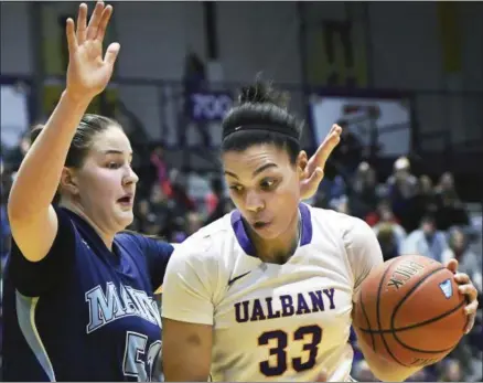  ?? JOHN CARL D’ANNIBALE — THE ALBANY TIMES UNION VIA AP ?? Albany’s Tiana-jo Carter, right, drives by Maine’s Fanny Wadlin during the America East Conference NCAA college basketball championsh­ip Friday, in Albany.