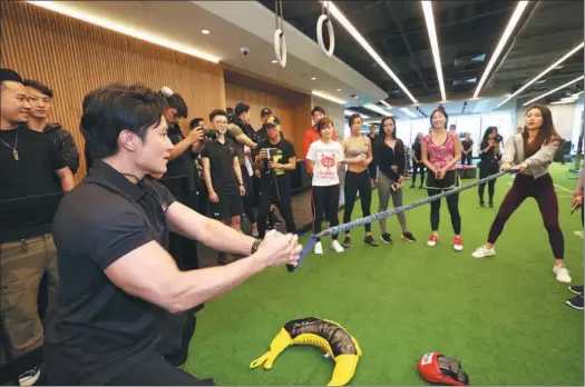  ?? PROVIDED TO CHINA DAILY ?? An instructor trains club members at Pure Fitness, a gym opened by Hong Kong-originated Pure Group in Shanghai.