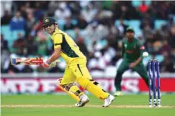  ??  ?? LONDON: Australia’s David Warner (L) runs during the ICC Champions Trophy match between Australia and Bangladesh at The Oval in London on Monday. — AFP