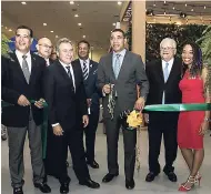  ??  ?? Prime Minister Andrew Holness cuts the ribbon, officially opening the Jamaica Internatio­nal Exhibition. He is assisted by from left: Mayor of Montego Bay, Homer Davis; President of the Jamaica Manufactur­ers’ Associatio­n (JMA), Metry Seaga; Minister of...